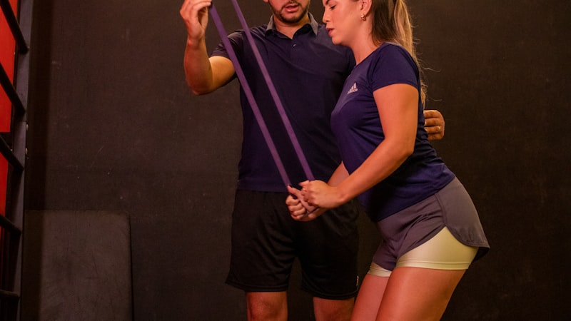 A therapist guiding a resistance band exercise